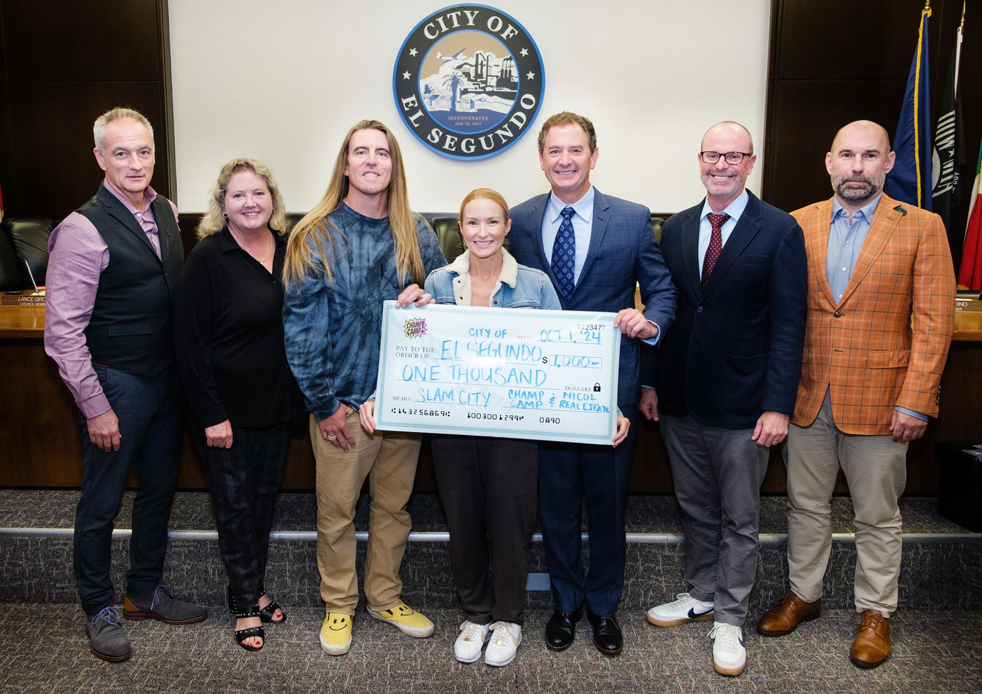 Kim Nicol and Trevor Elder present donation for skate park renovation to City Council